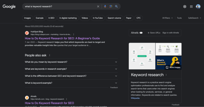 Google search results page for 'what is keyword research' featuring snippets from HubSpot Blog and Ahrefs, along with a People also ask section.